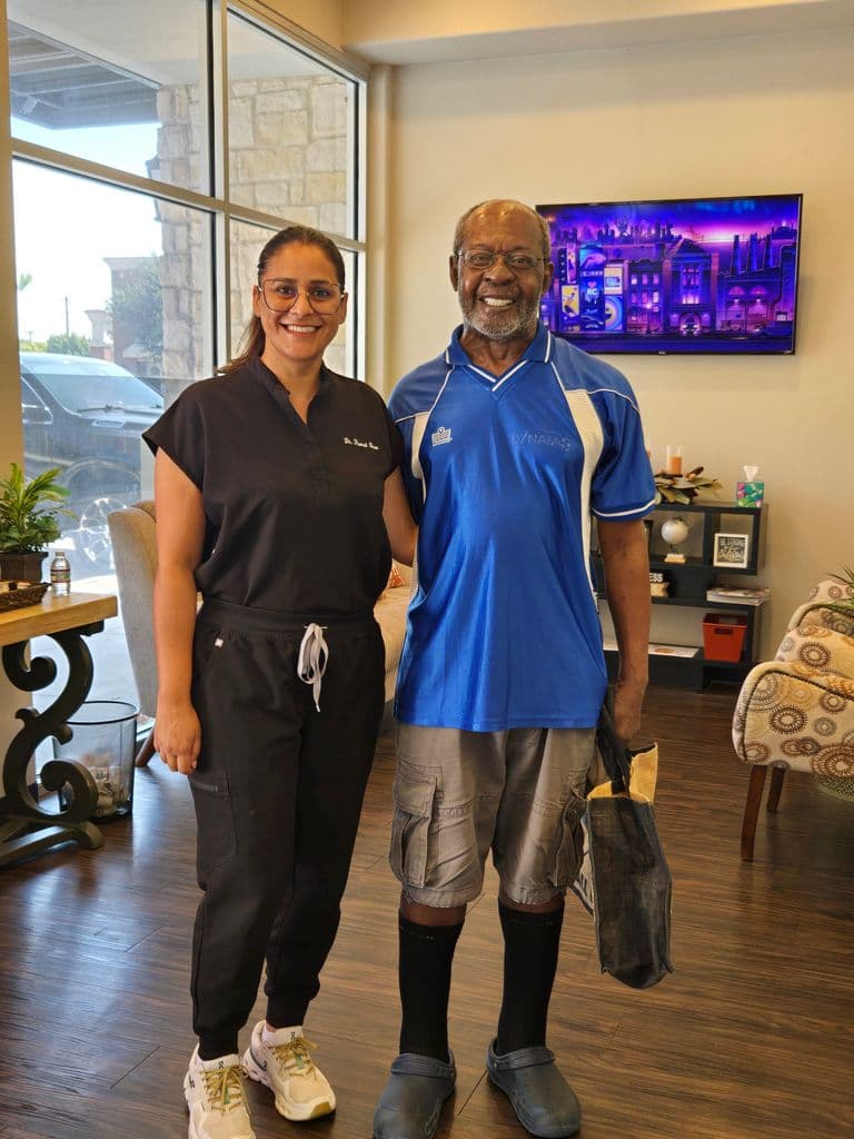 Dr. Kamal Brar with a patient at Smilecraft Dental